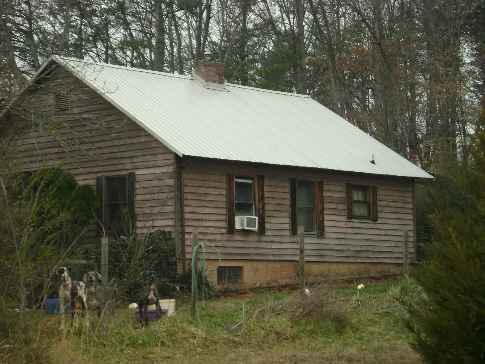 White metal roof on an old wood sided farmhouse, from a Asphalt Shingle Roof Repair job in Hollidaysburg